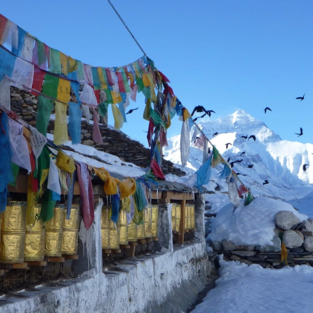 Vibrant prayer flags fluttering against a Himalayan mountain backdrop, capturing the essence of spiritual travel and adventure in Tibet.