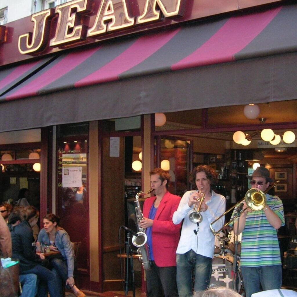 Enjoy live jazz music at this lively outdoor café in Monmarte, perfect for travelers wanting authentic cultural experiences and vibrant nightlife in a warm, friendly setting.