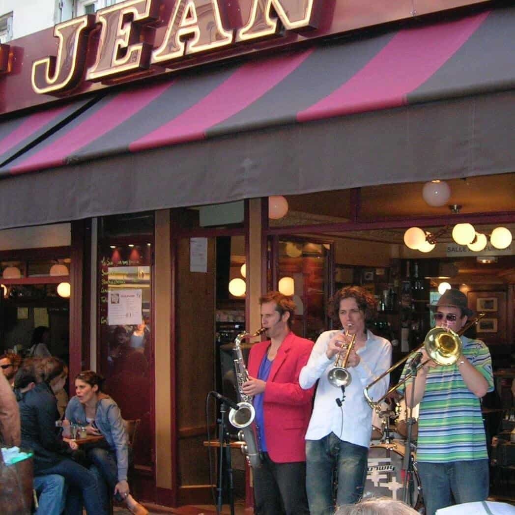 Enjoy live jazz music at this lively outdoor café in Monmarte, perfect for travelers wanting authentic cultural experiences and vibrant nightlife in a warm, friendly setting.